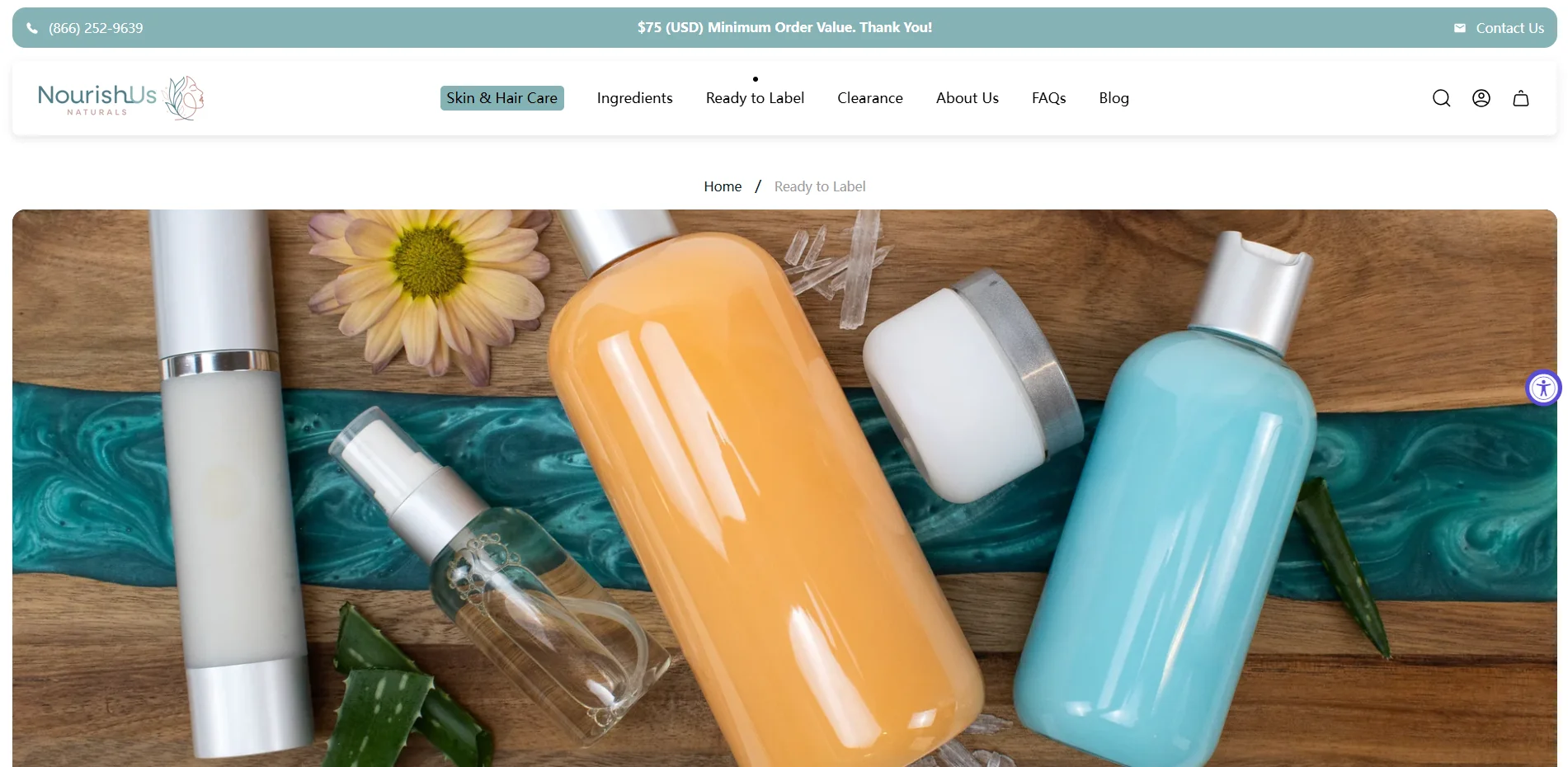 Assortment of skincare products including bottles and jars on a wooden surface, surrounded by aloe leaves, a flower, and decorative elements.